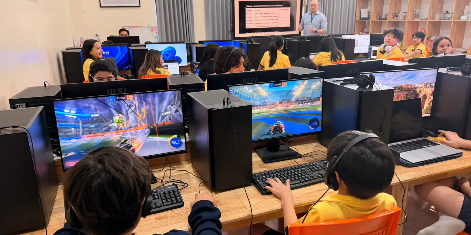 Students in a school esports lesson with their teacher