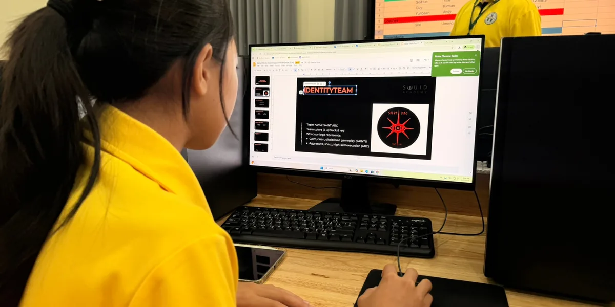 Student designing a team identity with Squid Academy branding